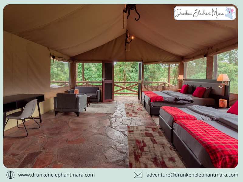 A spacious tent with two beds, red Maasai-check throws and a writing desk